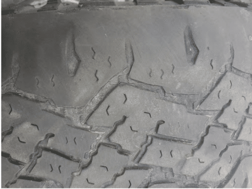 Car shaking due to worn tire in Hemlock, MI. Closeup image of worn tire at Hemlock Auto & Alignment.